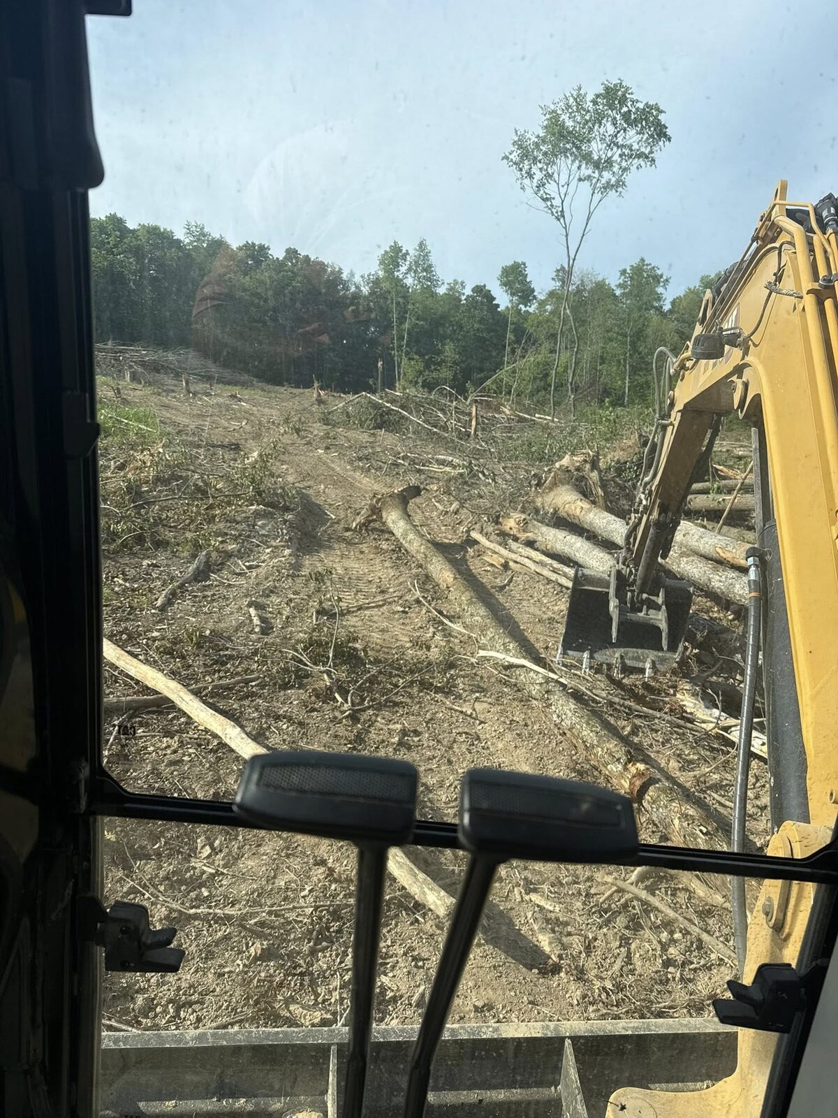 View from the excavator cab clearing a timbered hillside in Wayne County, WV
